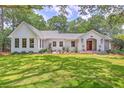 Charming home featuring a well-manicured lawn and beautiful landscape surrounded by mature trees offering a serene setting at 974 Cliffwood Dr, Mount Pleasant, SC 29464