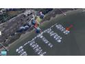 This aerial shows boats docked at a waterfront marina with nearby houses and clear water access at We 10Th St # A4, Folly Beach, SC 29439