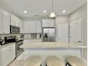 Bright kitchen features granite counters, stainless steel appliances, and ample white cabinetry at 1069 Lexi Ct, Ladson, SC 29456