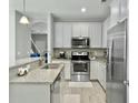 Modern kitchen boasting granite counters, stainless appliances, and a seamless flow to the living area at 1069 Lexi Ct, Ladson, SC 29456