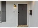 Close-up of the house number and front door with a decorative light fixture at 11 America St, Charleston, SC 29403