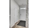 Bright hallway featuring tile flooring and white interior doors at 110 Cardinal Flower Ct, Moncks Corner, SC 29461