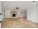 Bright living room featuring a decorative fireplace, ceiling fan, and wood-look floors at 1121 Armstrong Ave, Charleston, SC 29407