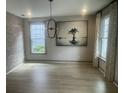 Stylish dining room with modern lighting fixture, large windows, and decorative artwork. Perfect for entertaining guests at 118 Magnolia House Dr, Summerville, SC 29486