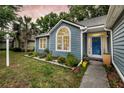 Landscaped front yard featuring flower beds leading to a blue front door at 1309 Llewellyn Rd, Mount Pleasant, SC 29464