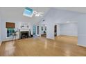 Bright living room with hardwood floors, a fireplace, and a vaulted ceiling with a skylight at 1309 Llewellyn Rd, Mount Pleasant, SC 29464