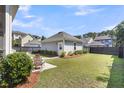 Well-maintained backyard with a detached garage and lush green lawn at 1392 Founders Way, Mount Pleasant, SC 29464