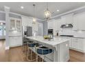 Modern kitchen with white cabinets, stainless steel appliances, and a large marble island at 1392 Founders Way, Mount Pleasant, SC 29464
