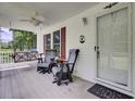 Cozy front porch features rocking chairs, swing, ceiling fan, and a welcome sign at 154 Patrick Ln, Summerville, SC 29483