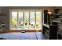 Bright and airy living room featuring a large window overlooking the well-manicured backyard and mature landscaping at 1866 Capri Dr, Charleston, SC 29407