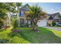 Charming two-story home with lush green lawn and attractive landscaping at 2017 Asher Loop, Summerville, SC 29485