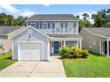 Inviting two-story home with blue siding, a one-car garage, and a landscaped front yard at 251 Coosawatchie St, Summerville, SC 29485