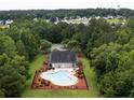 Aerial view of community pool surrounded by lush green trees with plenty of seating at 251 Coosawatchie St, Summerville, SC 29485