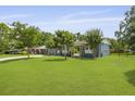 View of the lush, green lawn and exterior bench seating, perfect for enjoying the outdoors at 2605 Mona Ave, Charleston, SC 29414