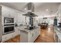 Bright kitchen featuring white cabinets, granite countertops, stainless steel appliances, and a central island at 2649 Starfish Dr, Johns Island, SC 29455