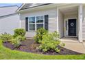 Charming front entrance with a decorative wreath and lush landscaping at 266 Torslanda Ln, Summerville, SC 29486