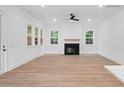 Bright living room with a modern fireplace, light wood floors, and multiple windows at 2872 Edenborough Rd, Johns Island, SC 29455