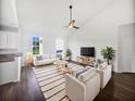 Bright living room with vaulted ceiling, ceiling fan, recessed lighting, a plush rug and comfortable seating at 2910 John Cabot Dr, North Charleston, SC 29420
