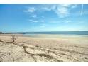 Serene beach view with clear blue skies and calm ocean waters at 3004 Point St, Edisto Island, SC 29438