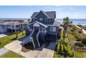 Charming raised beach house with stairs, porch, and scenic ocean views at 3004 Point St, Edisto Island, SC 29438