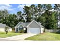 Attractive one-story home featuring a manicured lawn, a driveway, and mature landscaping for enhanced privacy at 3006 Central Ring Ct, Ridgeville, SC 29472