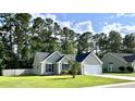 Cozy home with a well-kept lawn, inviting curb appeal and a driveway leading to an attached garage at 3006 Central Ring Ct, Ridgeville, SC 29472