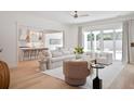 Bright living room with hardwood floors, neutral decor, and sliding glass doors to the patio at 311 Papa Charlie Way, Charleston, SC 29412