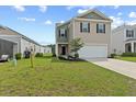 Charming two-story home featuring neutral siding, a two-car garage, and a well-maintained front lawn and landscape at 491 Cedarview Rd, Summerville, SC 29486