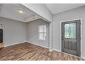 Inviting living room featuring laminate floors, and a stylish front door at 5023 Manor Rd, Hollywood, SC 29449
