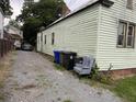 Exterior view of a two-story home with trash receptacles and a gravel driveway at 6 Orrs Ct, Charleston, SC 29403