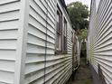 An awkward outdoor space between two houses with peeling paint and a rusted drainpipe at 6 Orrs Ct, Charleston, SC 29403