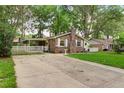 Brick house features a well-manicured lawn and a long driveway at 10 Teaneck Rd, Goose Creek, SC 29445