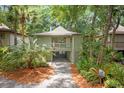 Beautiful elevated home with a small front porch, landscaped yard, and convenient drive-through carport at 1025 Scaup Ct, Kiawah Island, SC 29455