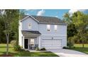 Charming two-story light blue home with a covered porch and a white garage door at 108 Lefton Lndg, Summerville, SC 29485