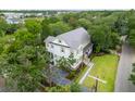 Aerial view of a two-story home with a metal roof surrounded by trees and lush landscaping at 108 Live Oak Dr, Mount Pleasant, SC 29464