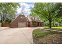 Traditional brick home featuring an attached garage, a long driveway and a well-manicured front lawn at 129 Dunbury Dr, Summerville, SC 29485