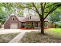 Traditional brick home featuring an attached garage, and established landscaping at 129 Dunbury Dr, Summerville, SC 29485