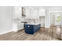 Open concept kitchen featuring white cabinets, subway tile backsplash, an island, and stainless steel appliances at 1350 Lucinda St, Mount Pleasant, SC 29466