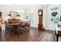 Elegant dining room with hardwood floors, wainscoting, and a traditional grandfather clock at 1517 Willtown St, Charleston, SC 29492