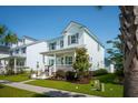 Inviting two-story home featuring a cozy front porch, lush landscaping, and a charming neighborhood setting at 1801 Sandybrook Dr, Mount Pleasant, SC 29466