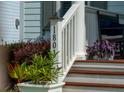 Welcoming front porch with elegant columns, comfortable seating, and lush greenery creating a relaxing outdoor space at 1801 Sandybrook Dr, Mount Pleasant, SC 29466
