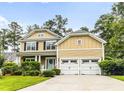 Beautiful two-story home with a two-car garage, well-manicured lawn, and classic architectural details at 188 Donning Dr, Summerville, SC 29483