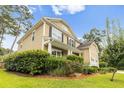 Well-maintained home with a two-car garage, mature trees, and an inviting covered front porch at 188 Donning Dr, Summerville, SC 29483