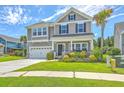 Charming two-story home featuring manicured lawn, attached garage, and inviting front porch at 207 Center Hill Ct, Summerville, SC 29485