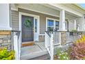 Inviting front porch featuring stone accents, decorative wreath, and charming details at 207 Center Hill Ct, Summerville, SC 29485