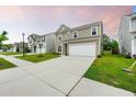 View of a two-story home with a wide driveway and a manicured lawn in a suburban neighborhood at 209 Hayworth Rd, Summerville, SC 29486