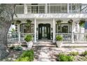 Inviting front porch with potted plants and hanging flowers at 2142 Golfview Dr, Charleston, SC 29412