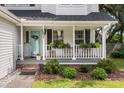 Inviting front porch decorated with plants and a light blue painted front door at 237 Dillard Dr, Goose Creek, SC 29445