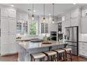 Elegant kitchen featuring white cabinetry, a gray island with seating, and stainless steel appliances at 2489 Daniel Island Dr, Daniel Island, SC 29492