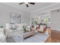 Bright living room with hardwood floors, stylish furnishings, and an open view to the kitchen at 2489 Daniel Island Dr, Daniel Island, SC 29492